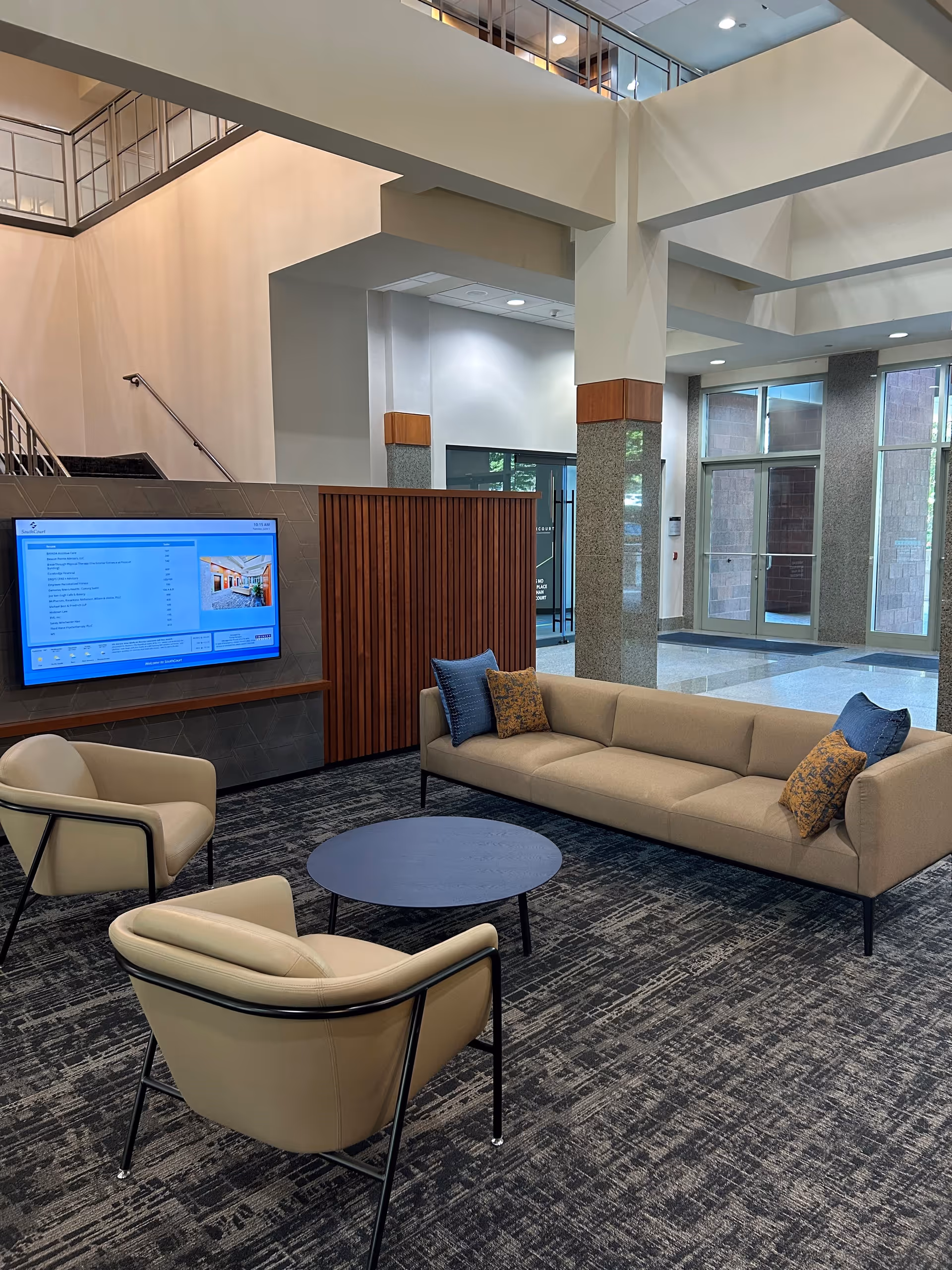 BAYADA Assistive Care lobby with beige seating, a blue round table, and large windows.