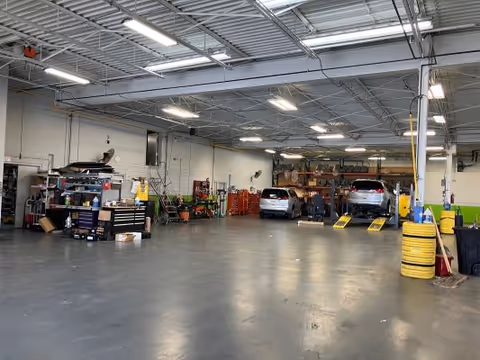MobilityWorks workshop interior featuring cars on lifts in a spacious service bay