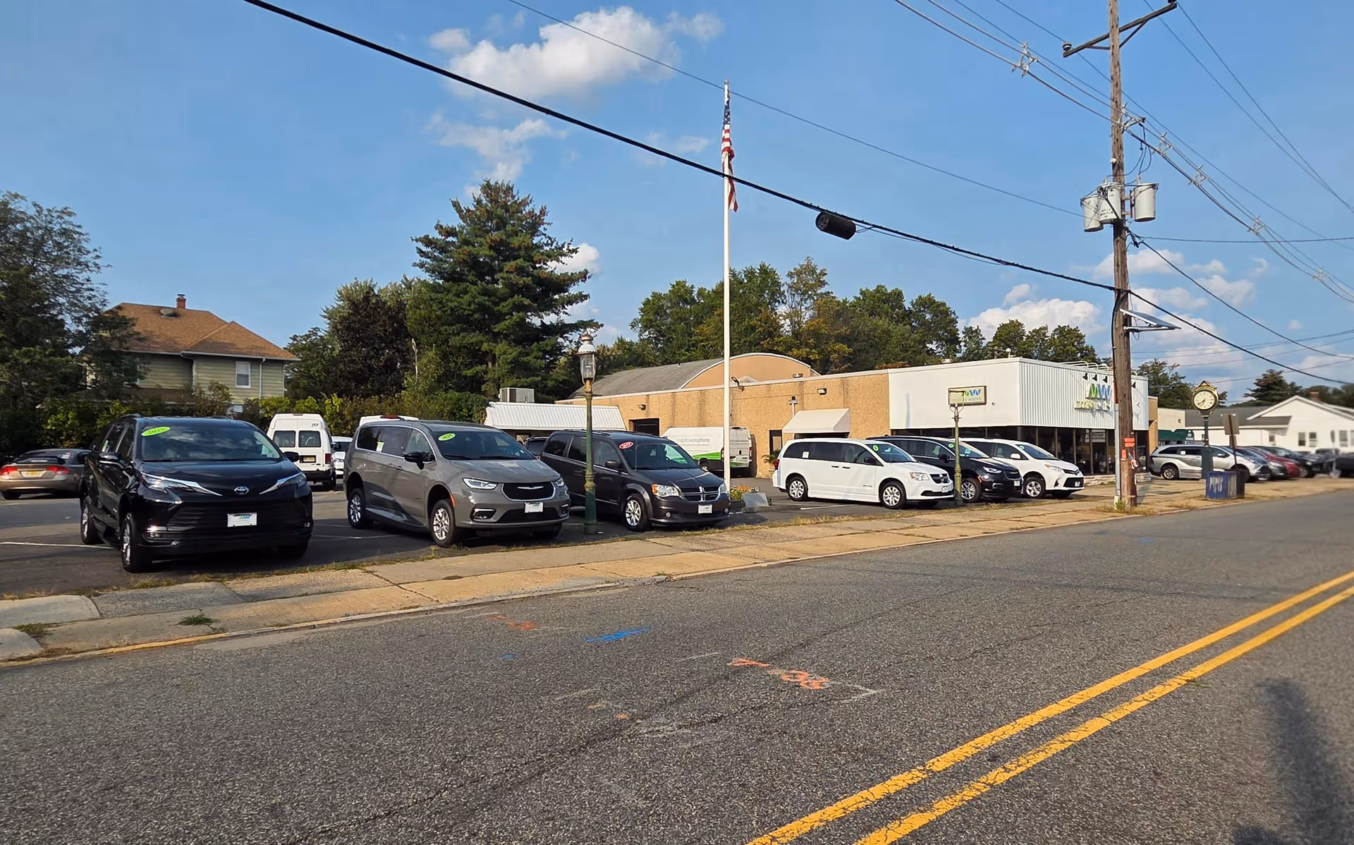 Exterior view of MobilityWorks with a row of parked cars along the street.