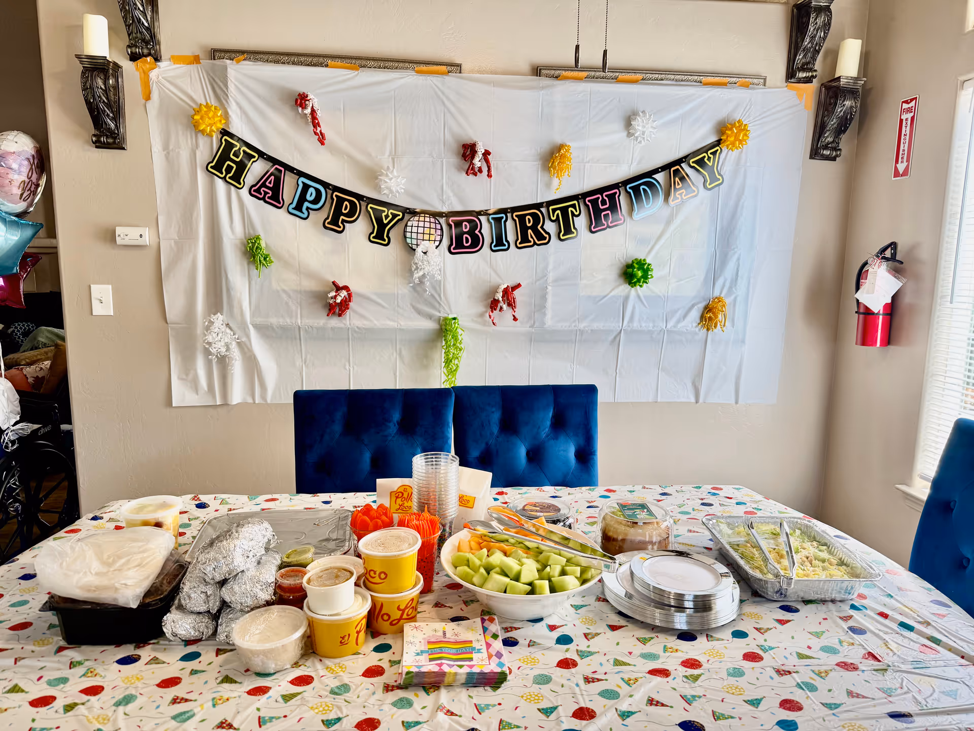 Birthday celebration setup on a dining table with a colorful banner in a dining room.