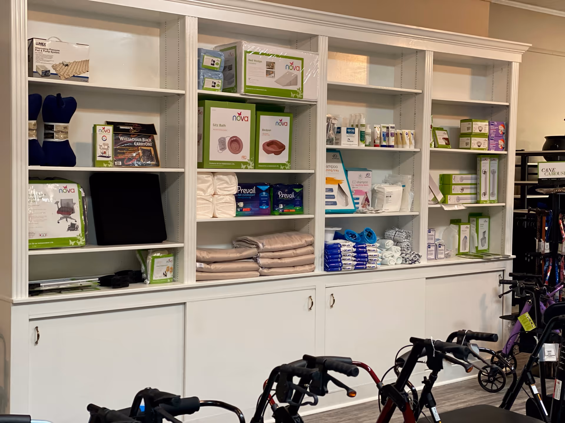 Wide white shelves display medical supplies and mobility devices in an interior showroom.