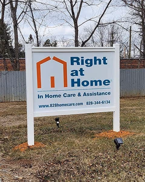 Outdoor lawn sign displaying Right at Home for in-home care services.