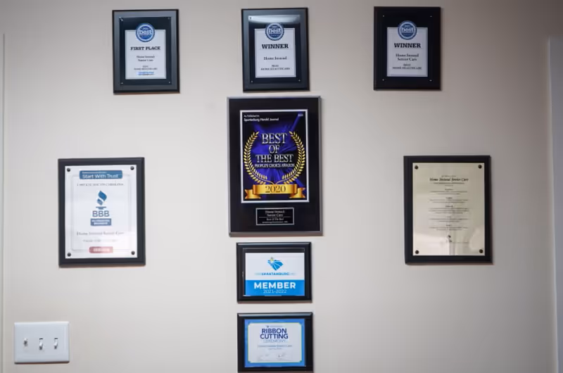Interior wall showcasing multiple framed awards and certificates.
