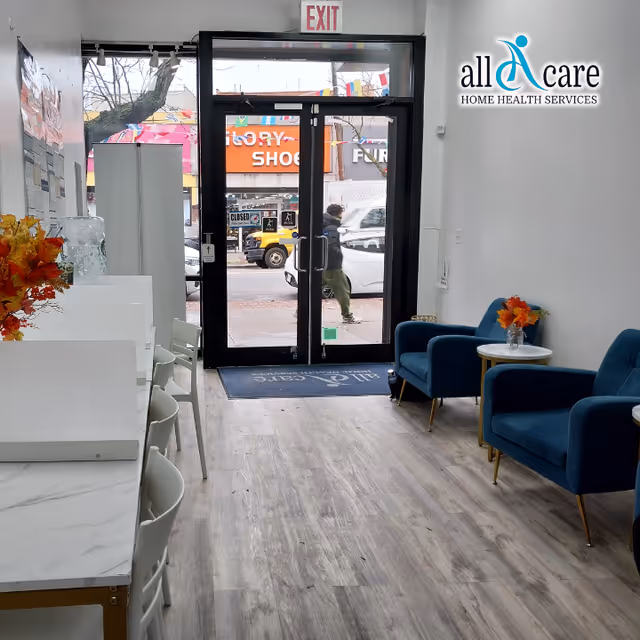 Reception lobby of All Care Home Health Services with glass entrance and blue seating.