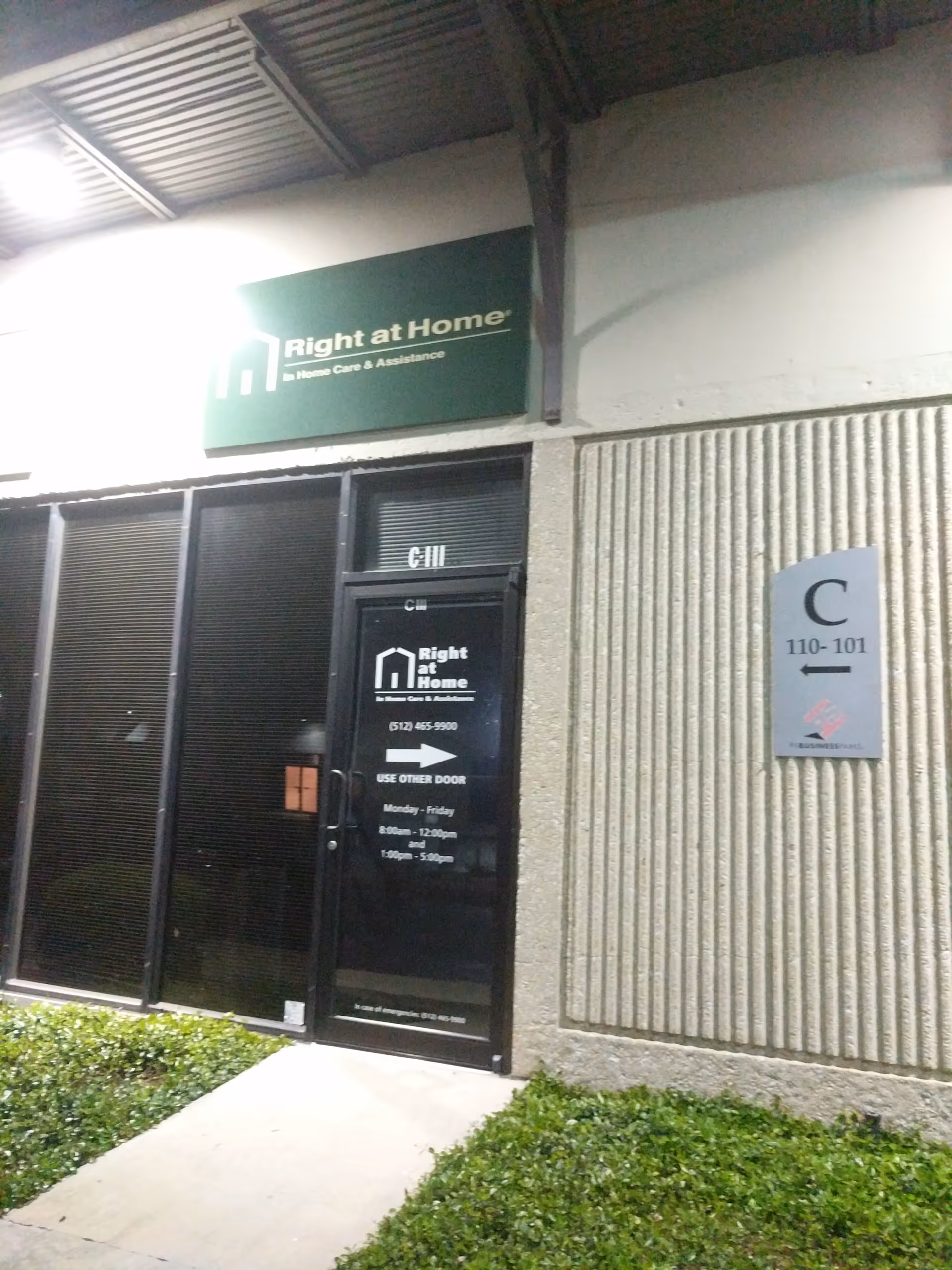 Exterior view of Right at Home entrance with sign and glass door.