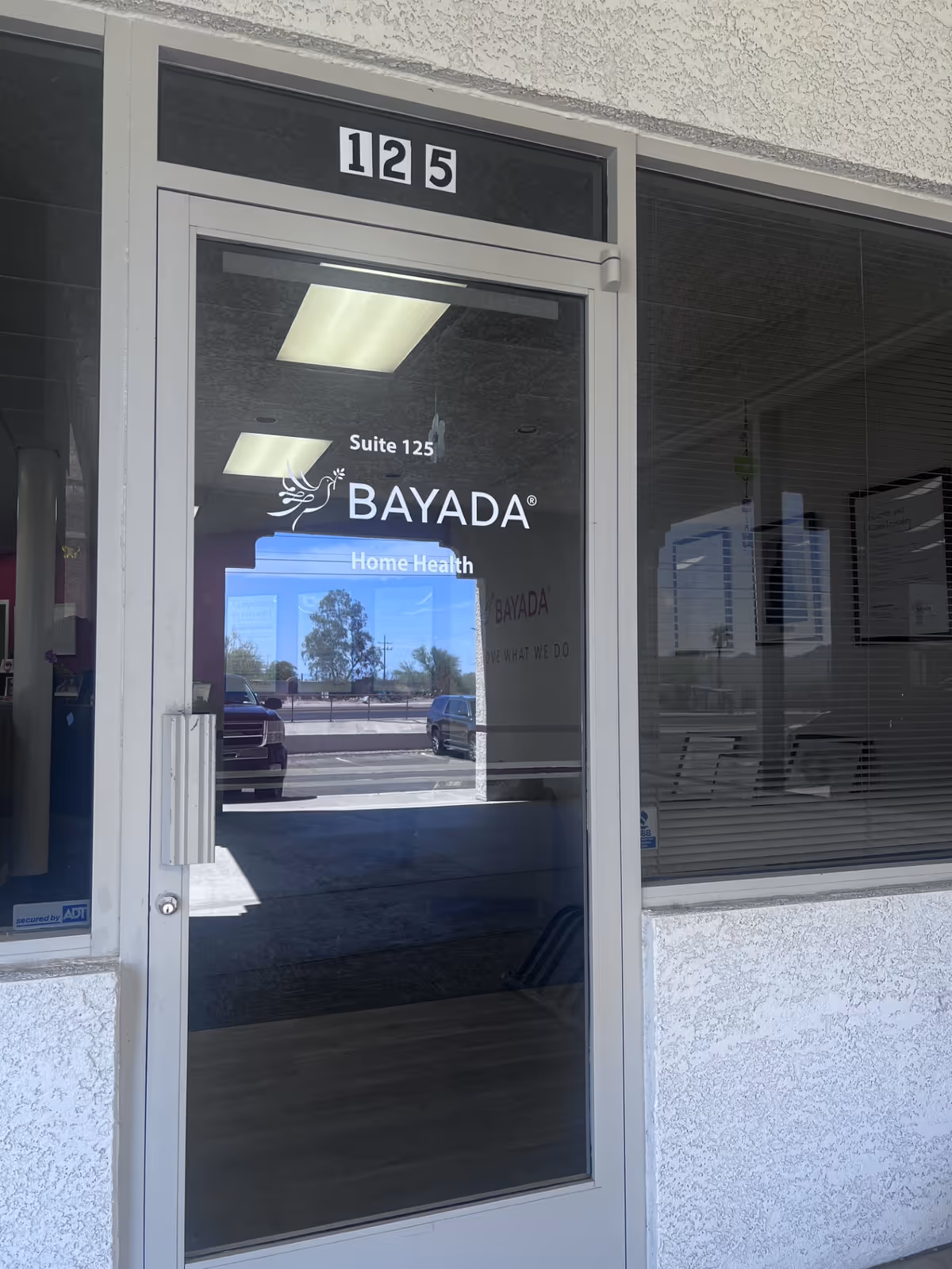 Glass door entry displaying BAYADA Home Health signage and Suite 125 above the doorway.