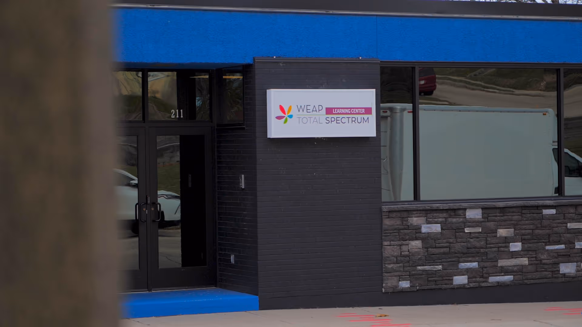 Exterior view of WEAP sign at the entrance of a modern building.