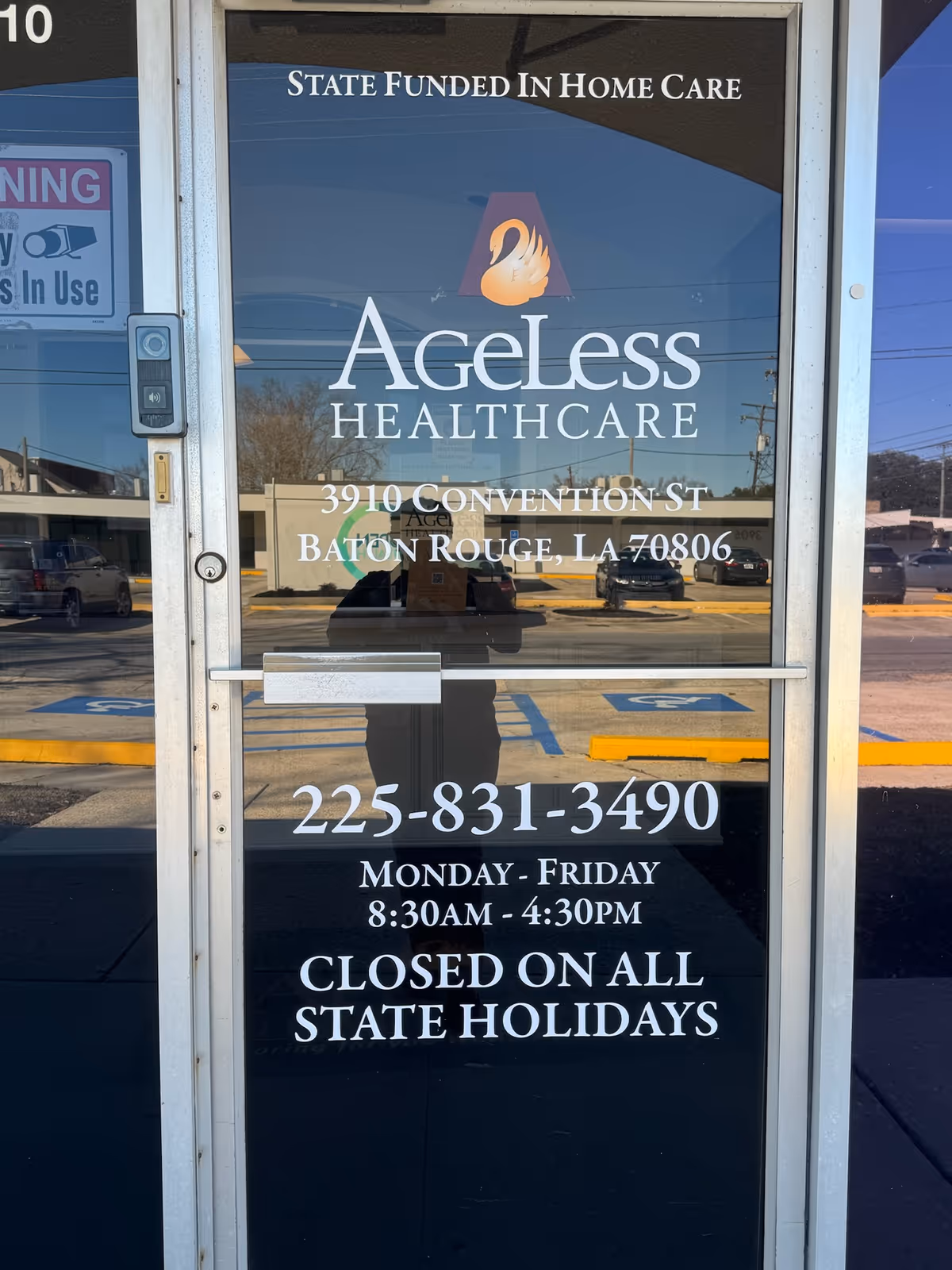 Glass storefront door showing Ageless Healthcare logo, address, and hours.