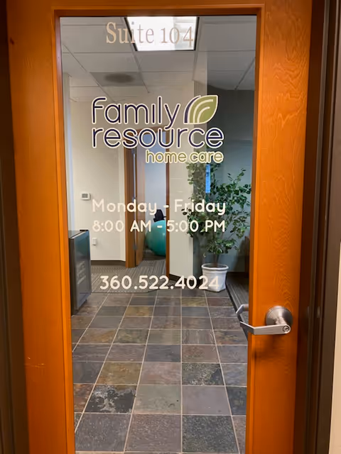 Glass door featuring Family Resource Home Care logo and suite 104 in a tiled hallway