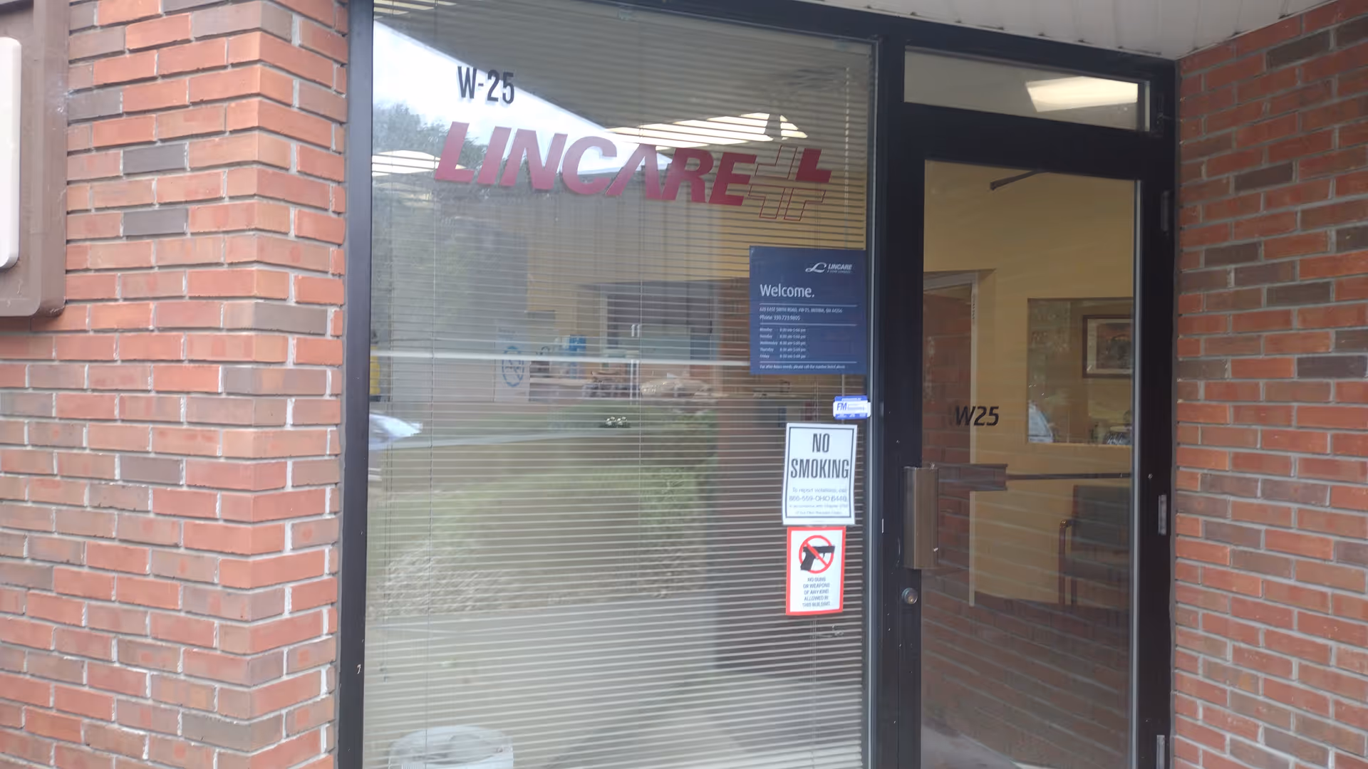 Brick exterior with a glass entrance and visible LINCARE signage.