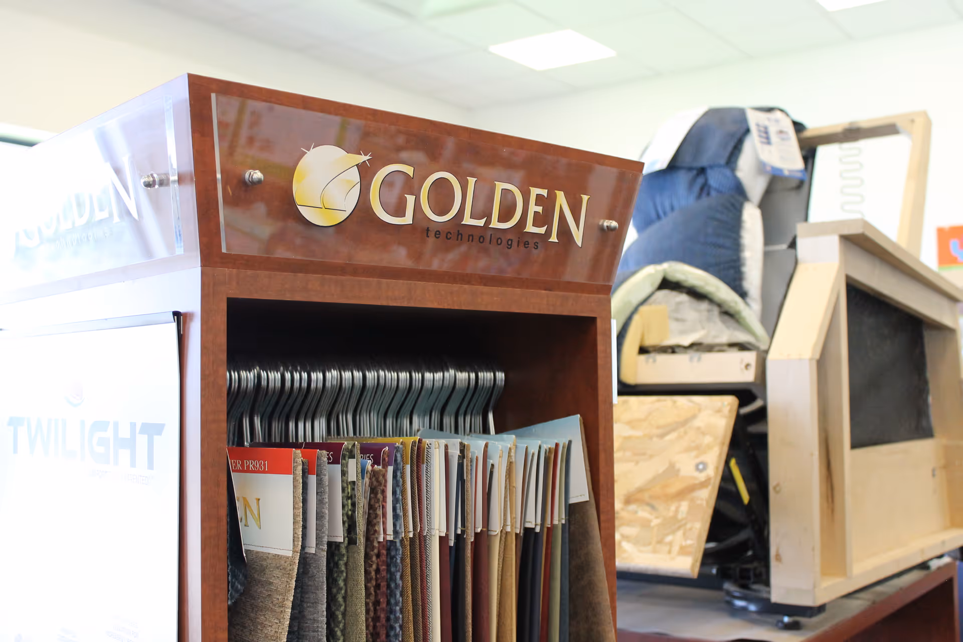 Interior showroom featuring fabric swatches and a Golden Technologies display cabinet.