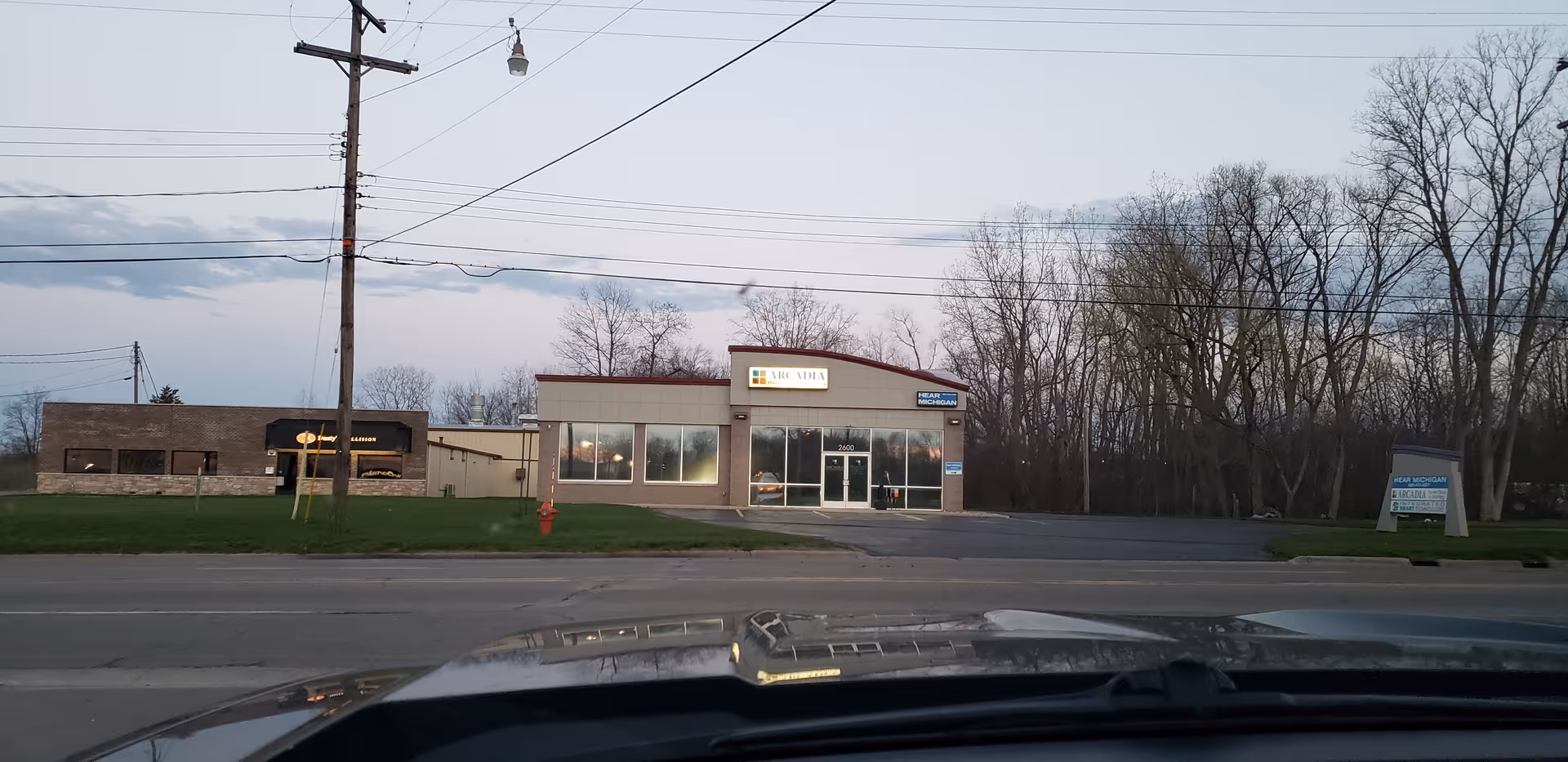 Street view of Arcadia Home Care and Staffing storefront along a road with power lines.