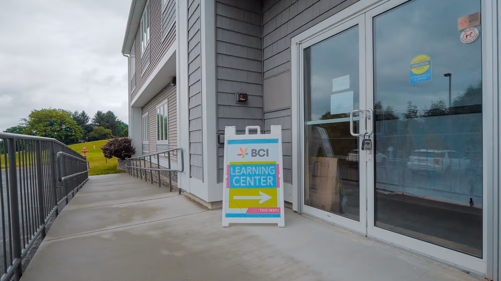 Exterior view of Behavioral Concepts BCI building with a Learning Center sign near the entrance.