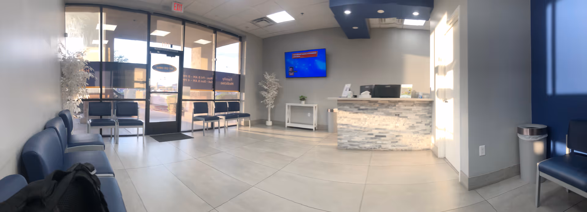 Lobby area of a senior living facility with seating, reception desk, and glass entrance