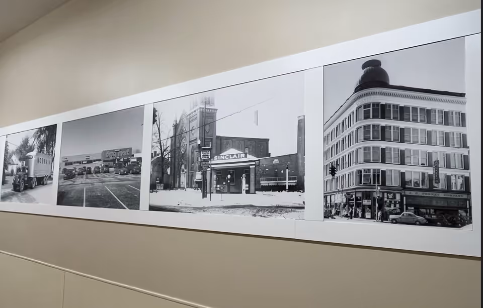 A row of black-and-white storefront photos decorates an interior hallway.