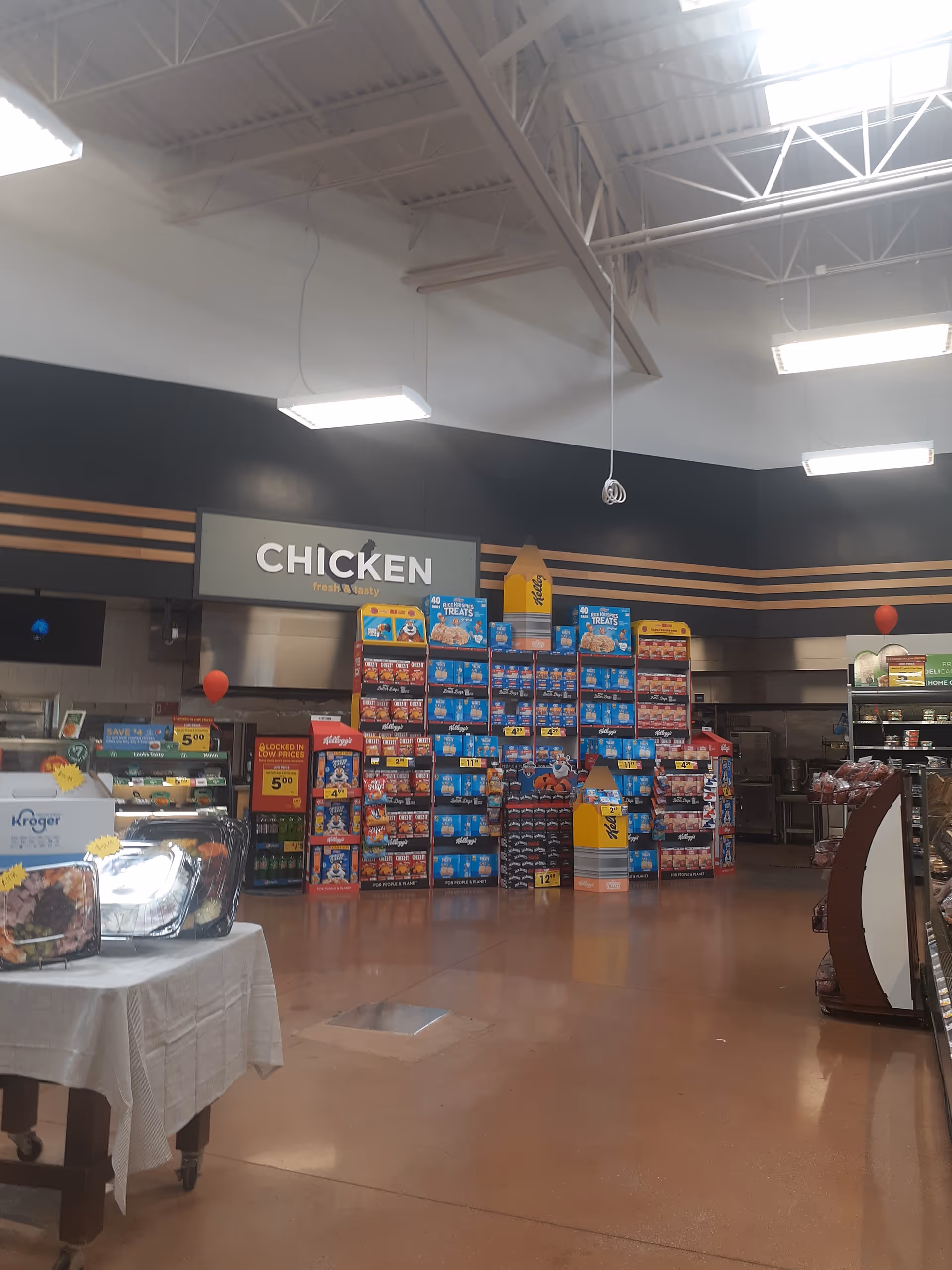 Kroger store interior with a large CHICKEN sign and product displays