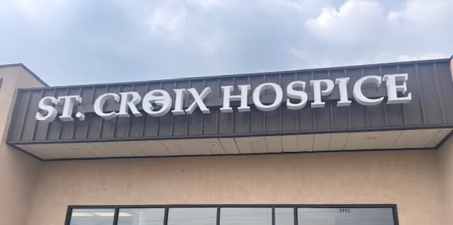 Exterior view of a building with a large ST. CROIX HOSPICE sign above the entrance.