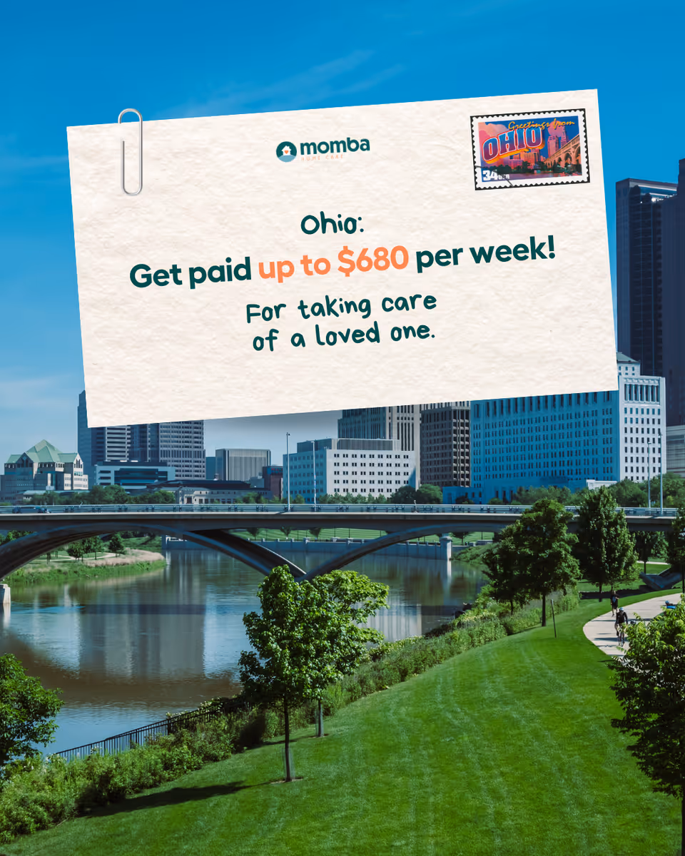 A large white advertisement card clipped over a city riverfront park.