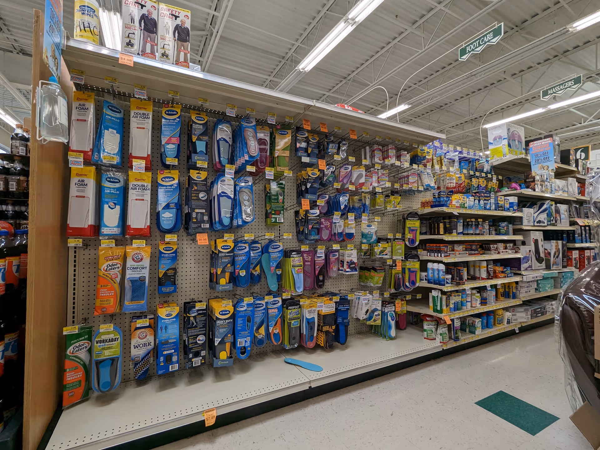 Inside a Discount Drug Mart aisle with assorted foot care products and supplies.