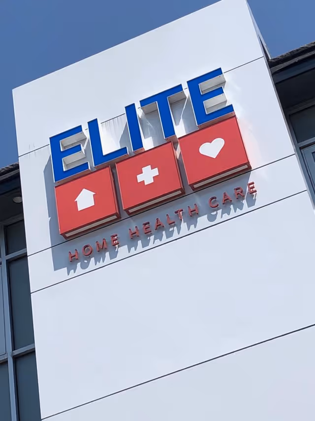 Exterior view of Elite Home Health Care sign on a white building facade.