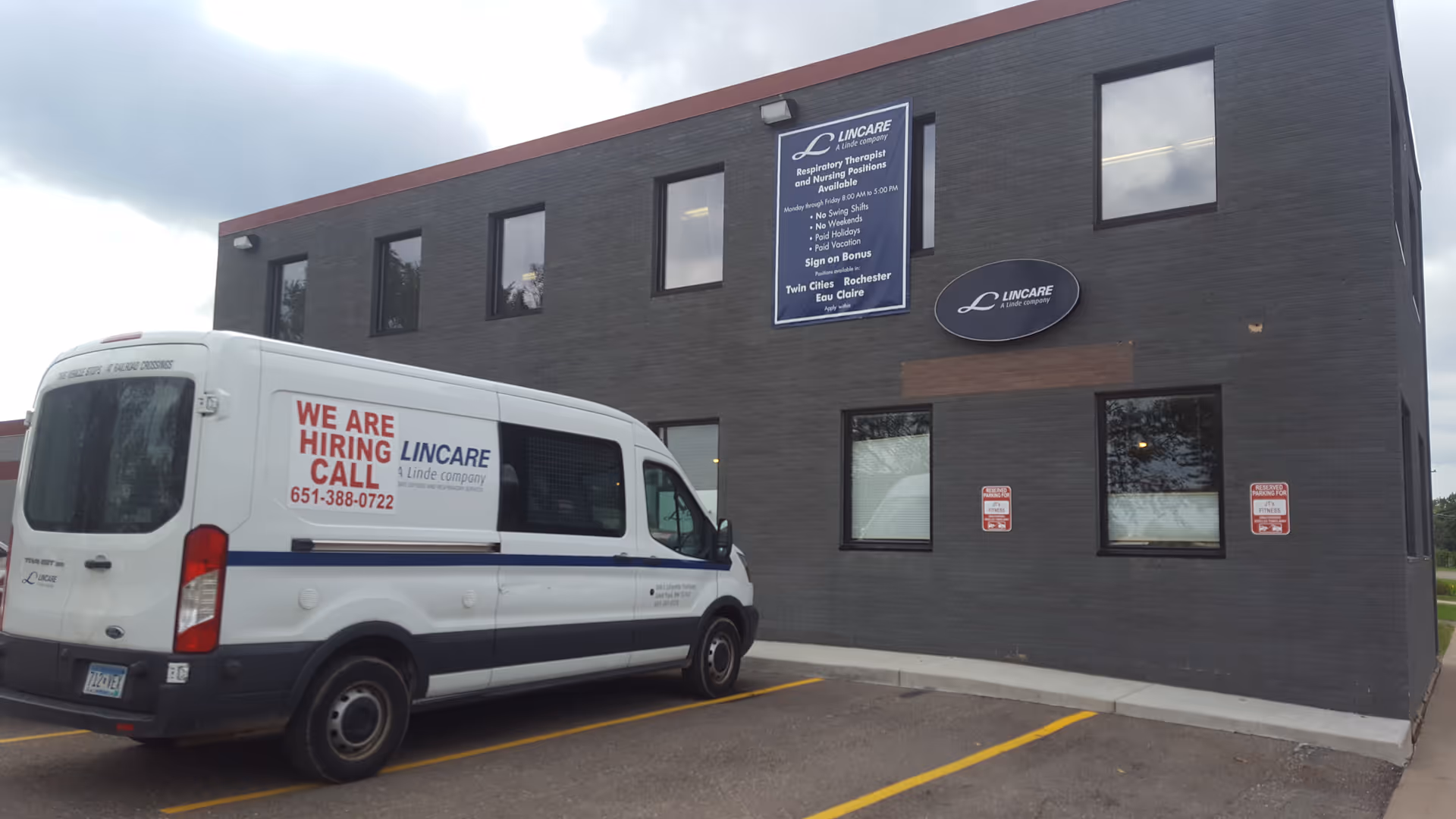 Exterior of a Lincare facility with a white van reading 'We Are Hiring' parked out front.