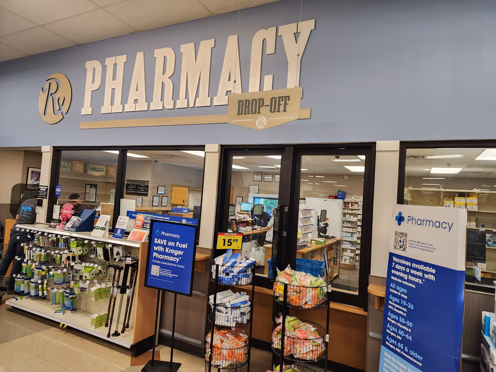Interior of a Kroger Pharmacy with counters, products, and customers.