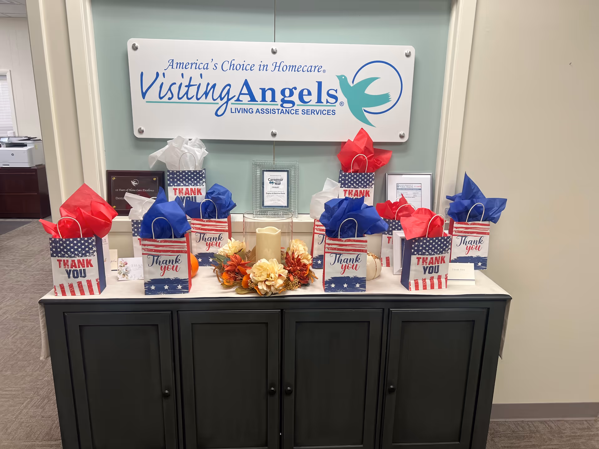 Interior lobby counter with gift bags and a Visiting Angels sign on the wall.