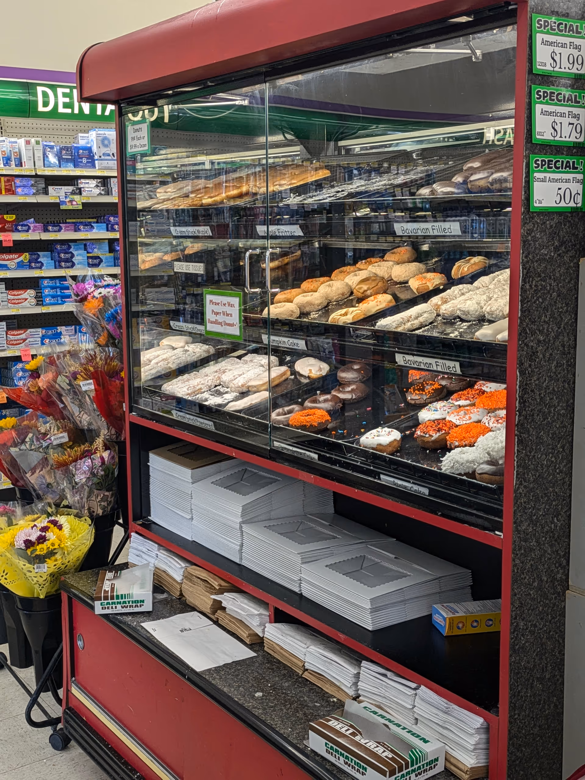 Donut display case with assorted pastries inside Discount Drug Mart.