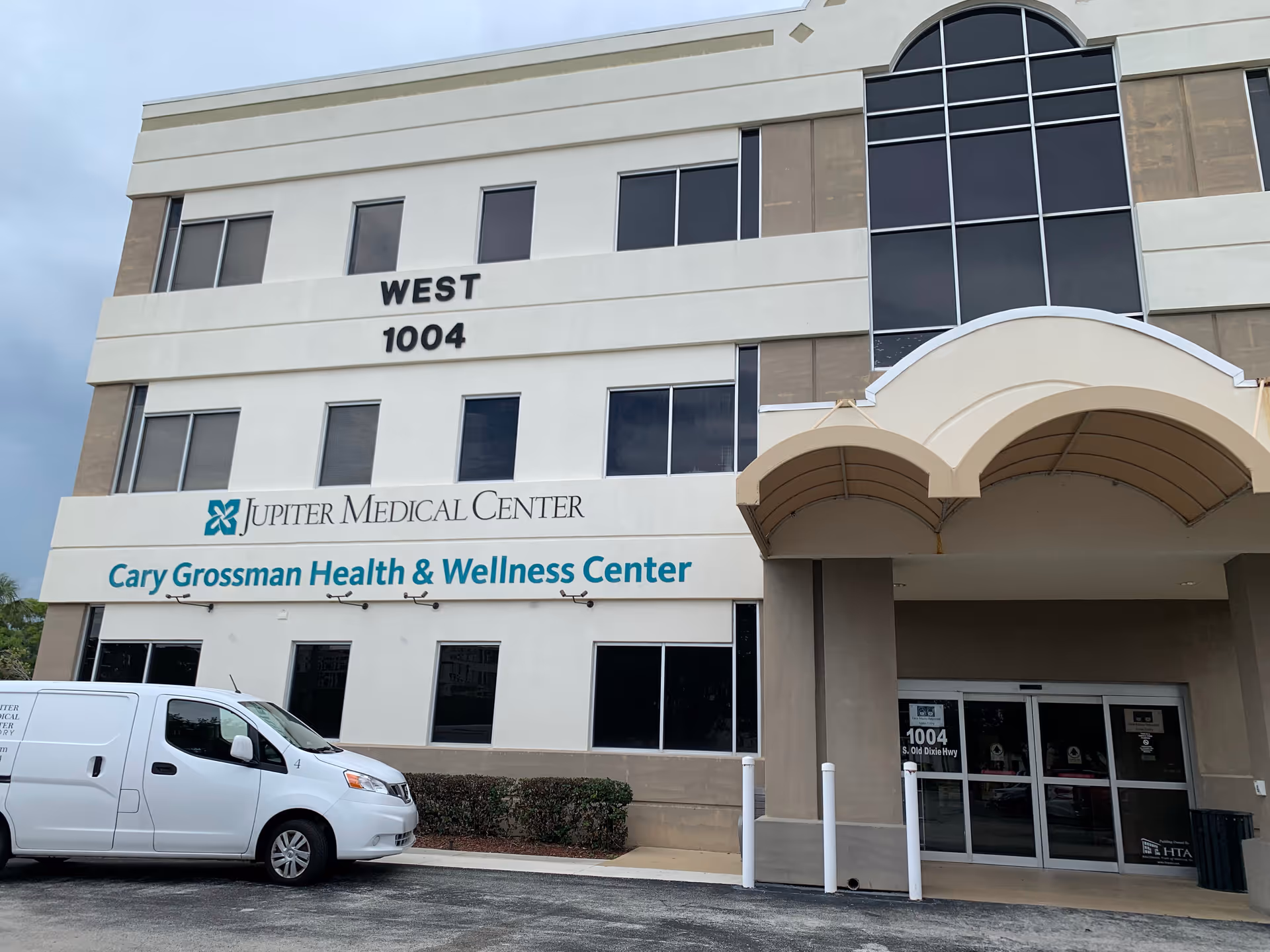 Exterior view of a multi-story medical center with Cary Grossman Health & Wellness Center signage.
