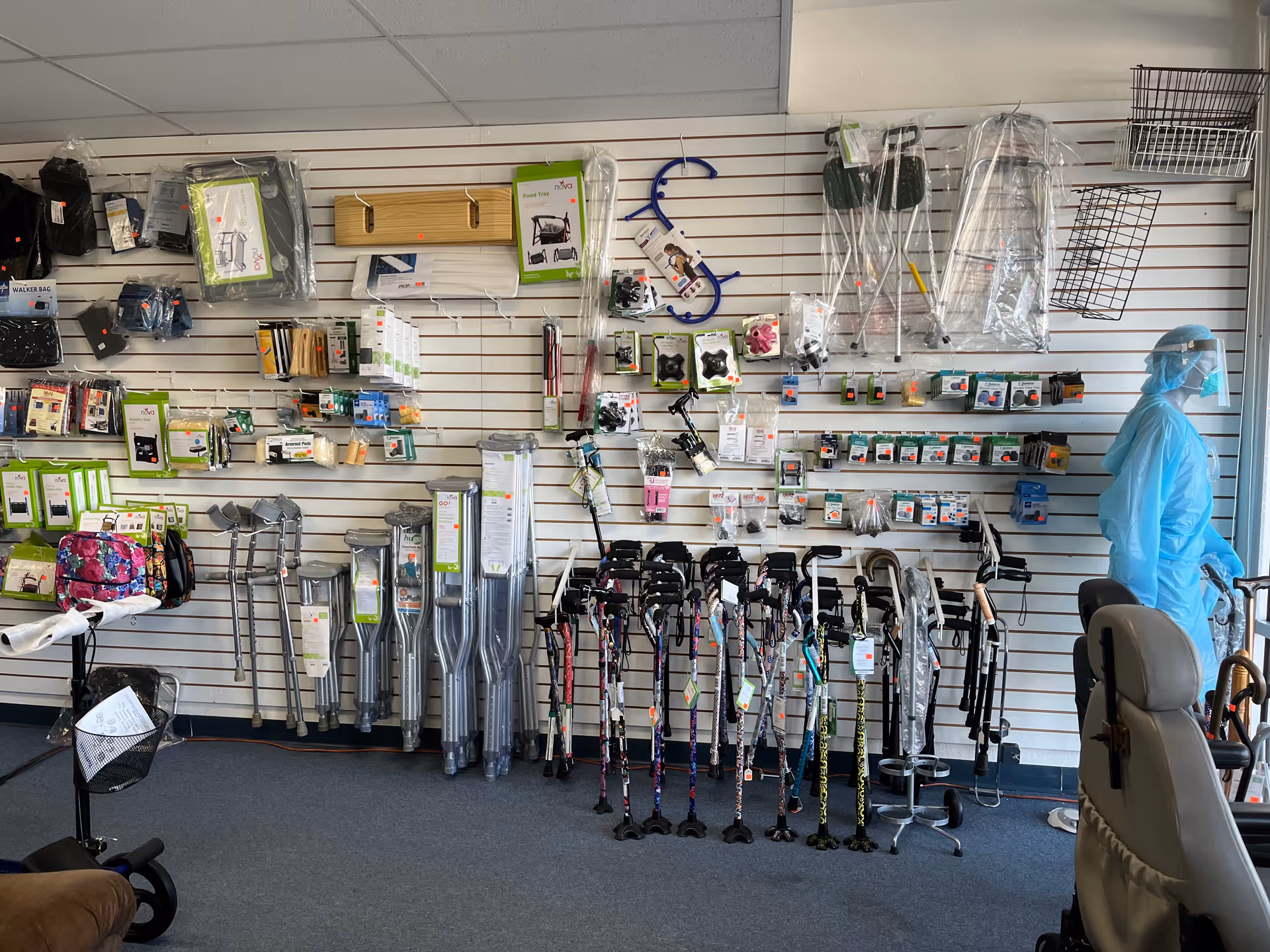 Interior store area with walkers, canes, and medical supplies on wall shelves.