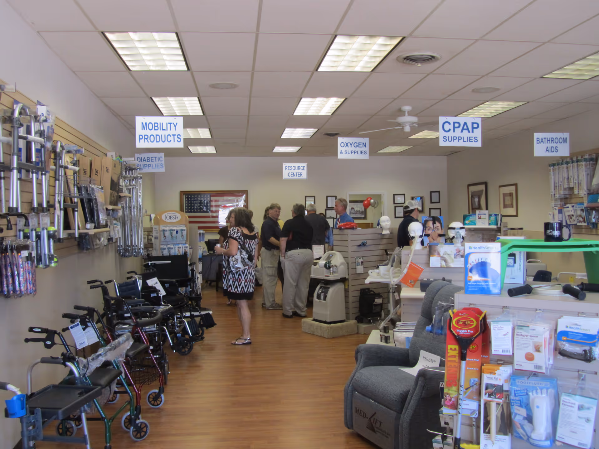 Interior of a senior living facility medical-supply store with walkers and customers.