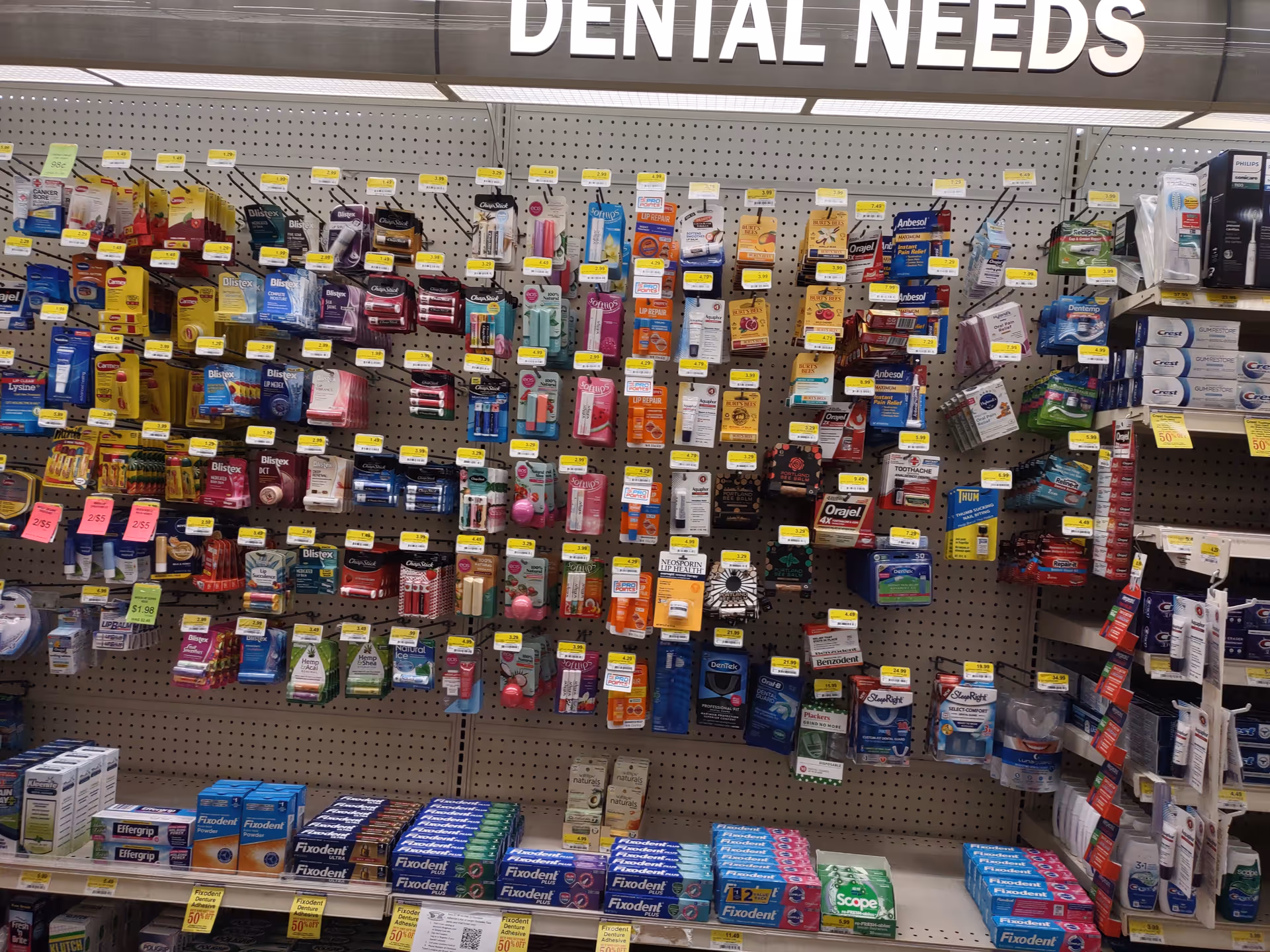 Shelf filled with assorted dental care products in a Discount Drug Mart aisle.