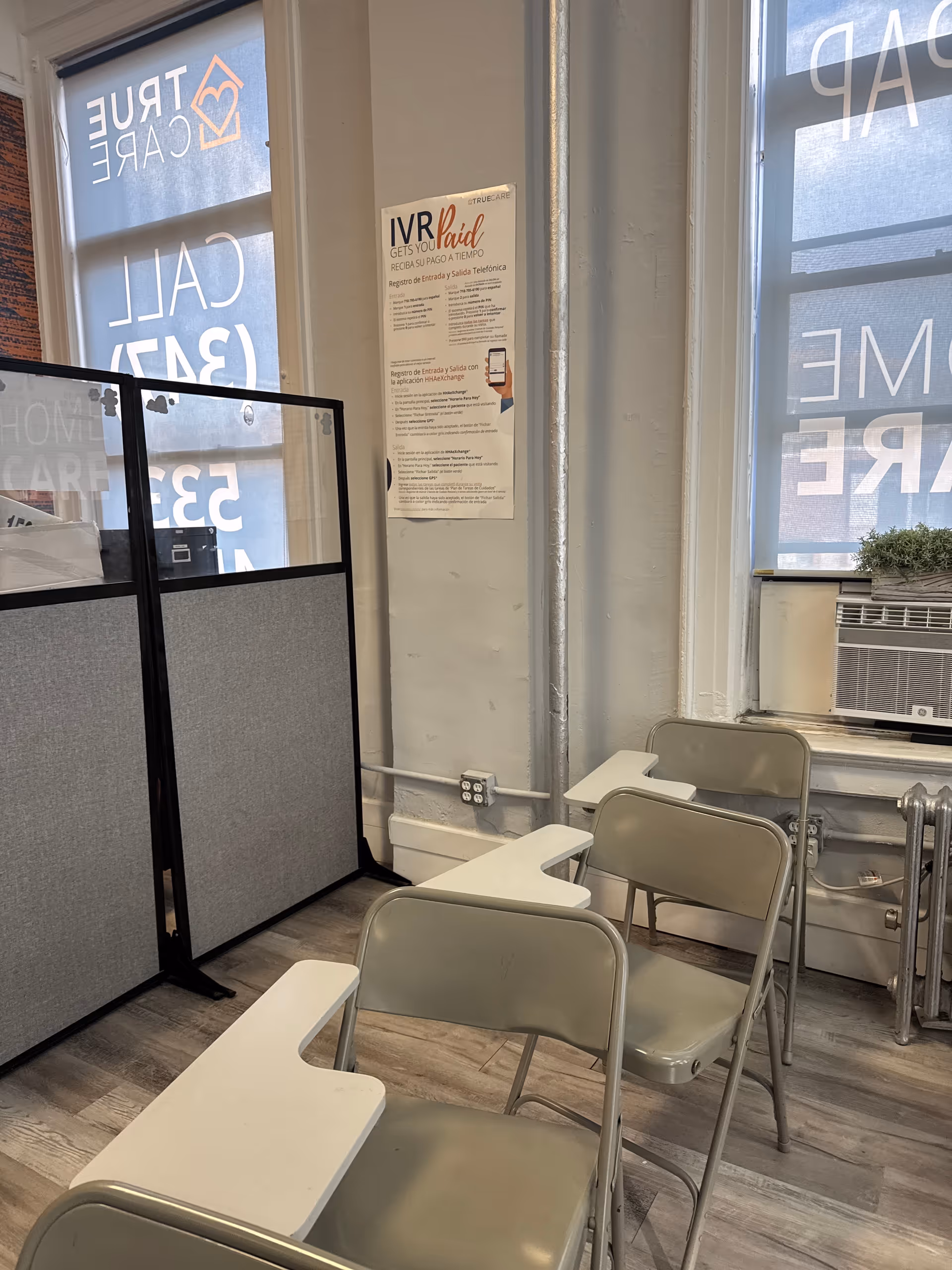 Office-like waiting area with chairs and partition screens.