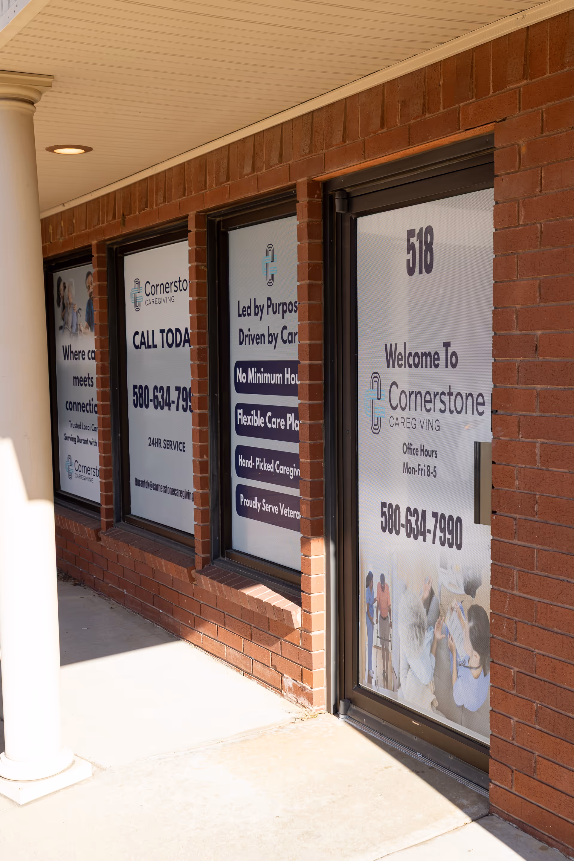 Brick exterior of Cornerstone Caregiving with large window signs and a welcoming door.