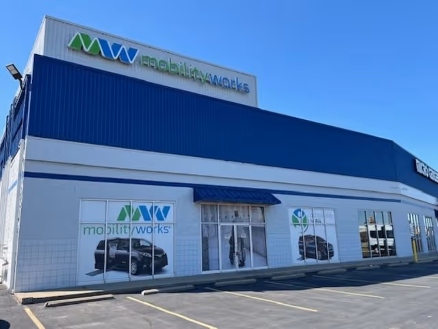 Exterior view of MobilityWorks facility with blue awning and storefront windows