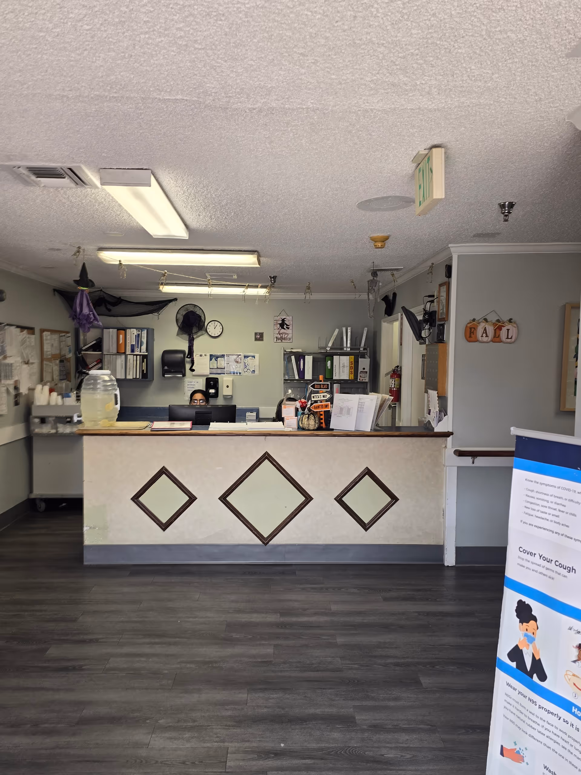 Reception area of a senior care facility with a front desk and staff.
