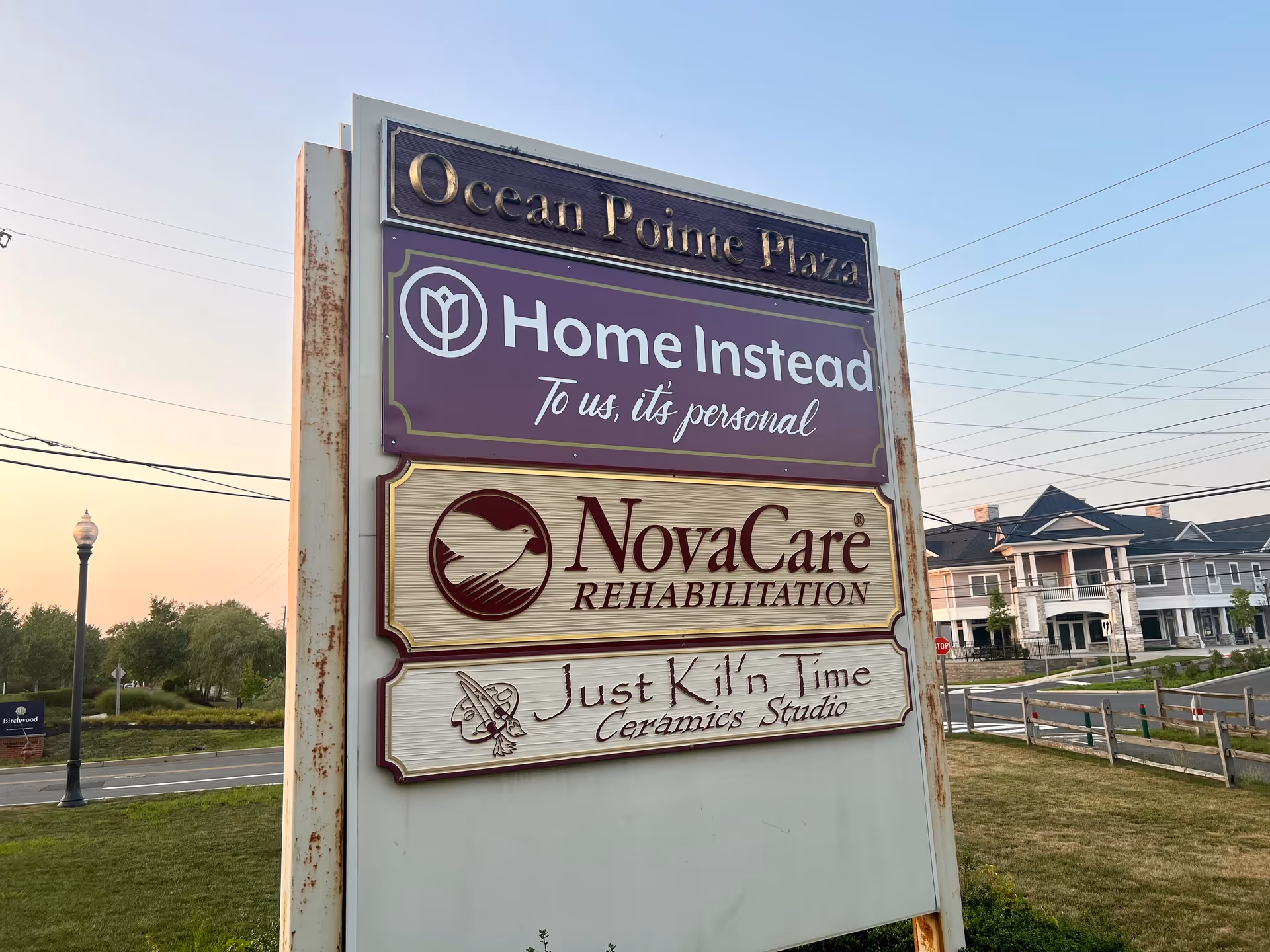 Outdoor signboard for Ocean Pointe Plaza featuring Home Instead and NovaCare signs