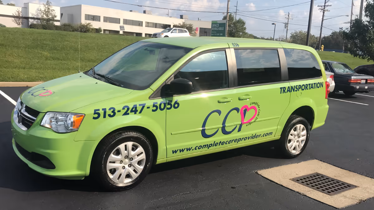 Bright green Complete Care Providers transportation van parked in a lot.