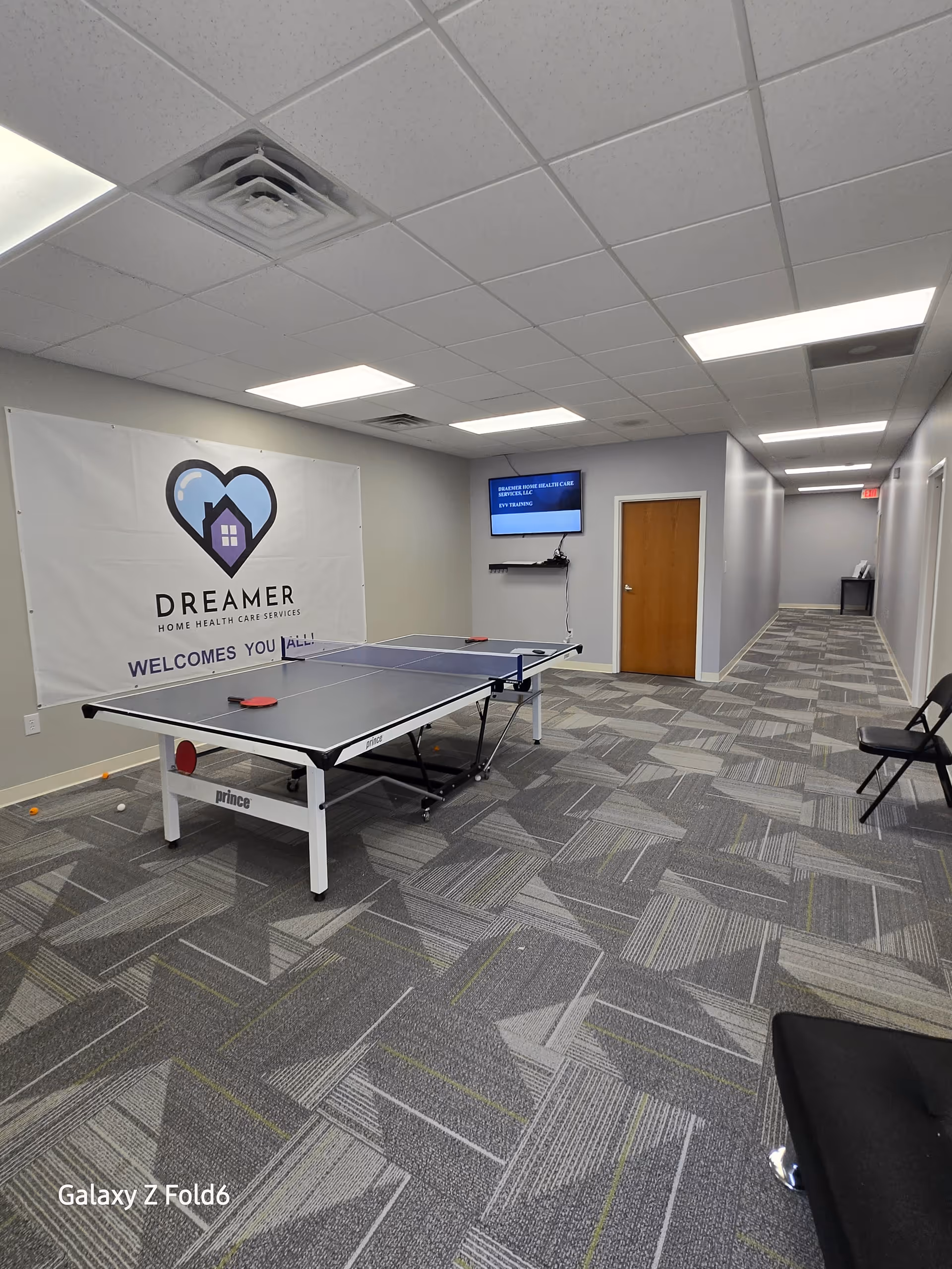 Indoor activity room at Dreamer Home Health Care Services with a ping-pong table.