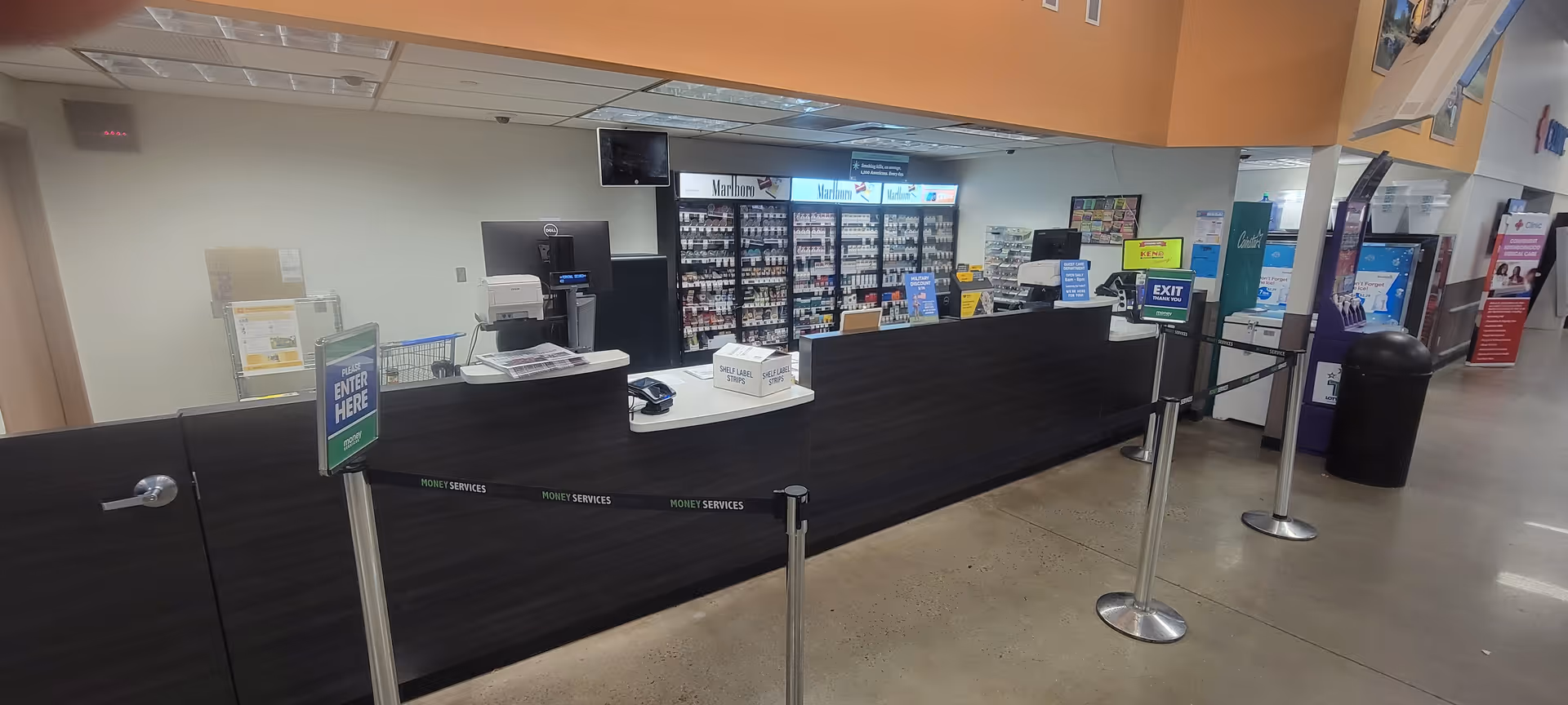 Long Kroger Pharmacy counter with shelves and signage inside.