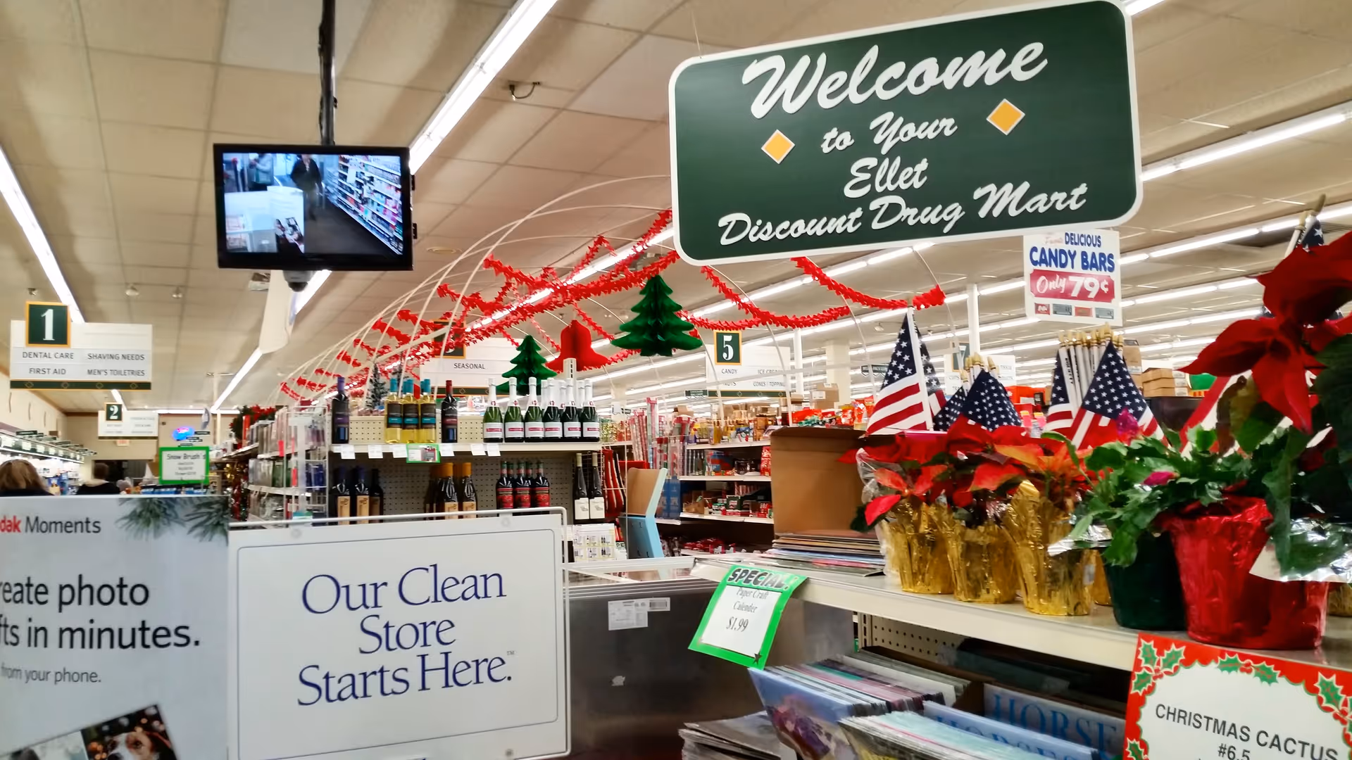 Interior of Discount Drug Mart with holiday decorations and shelves full of products.