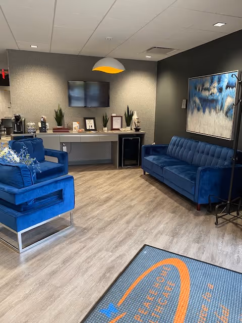 Blue upholstered seating area in a Chesapeake Home Health Care lobby.