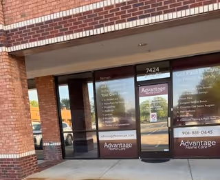 Brick storefront with glass doors labeled Advantage Home Care and visible signage.