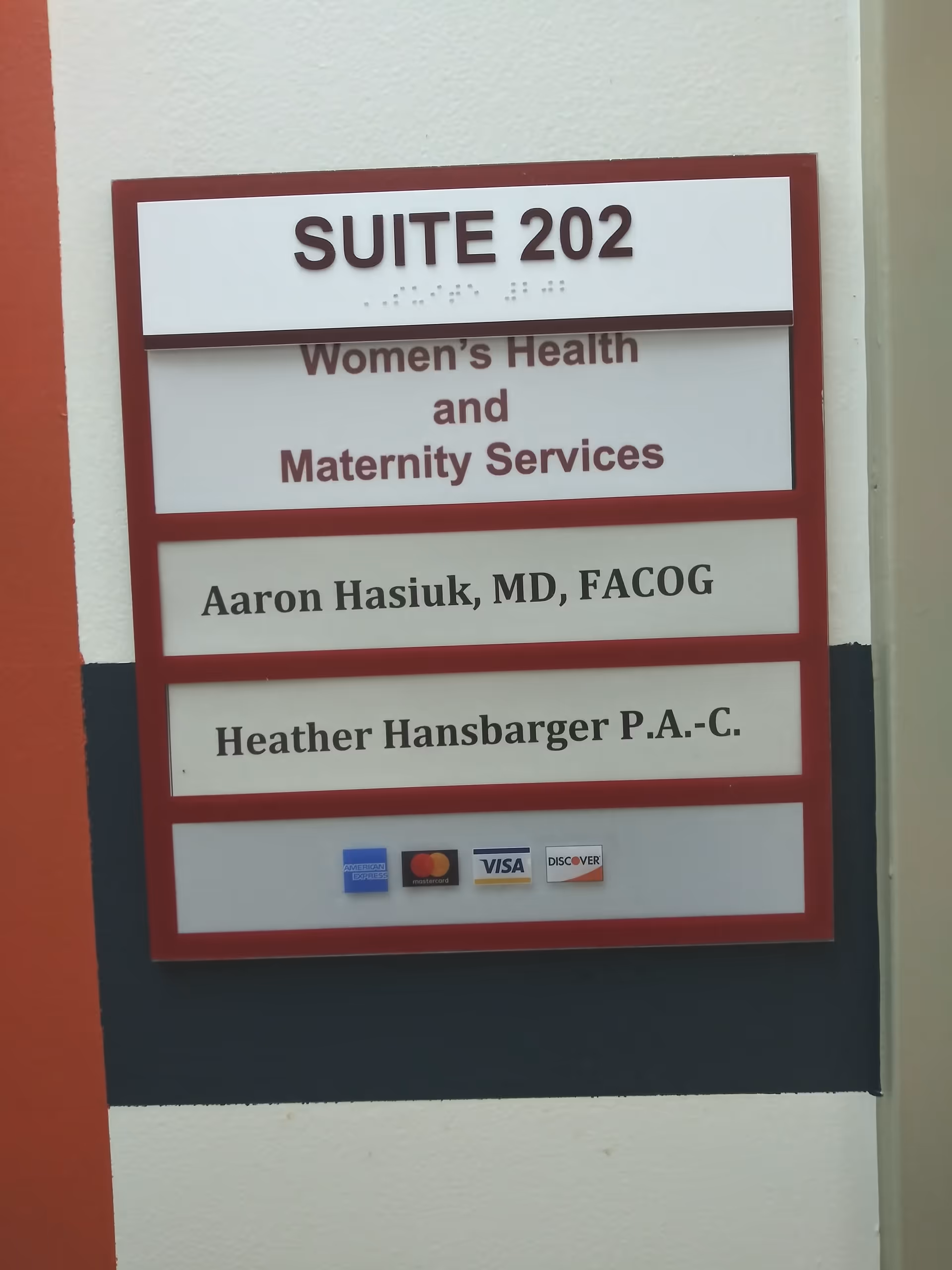 Interior wall sign reading Suite 202 for Women's Health and Maternity Services.