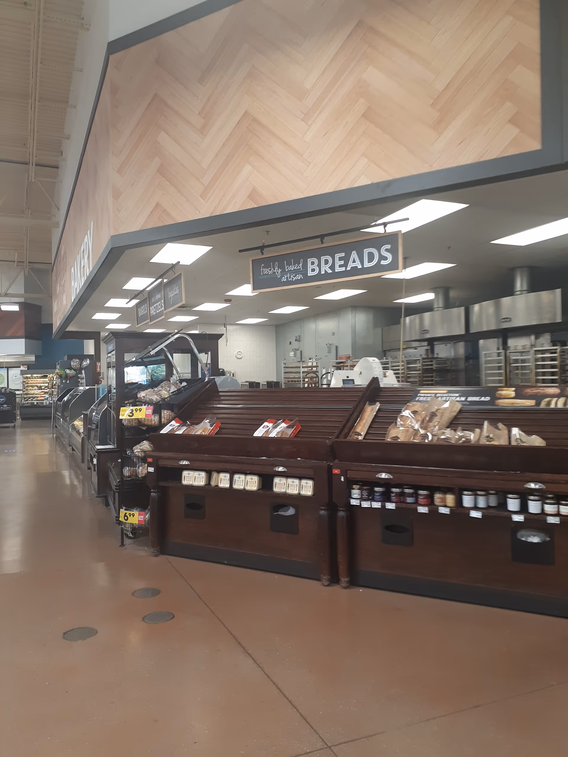 Inside a Kroger bakery area with bread displays and a sign reading BREADS.