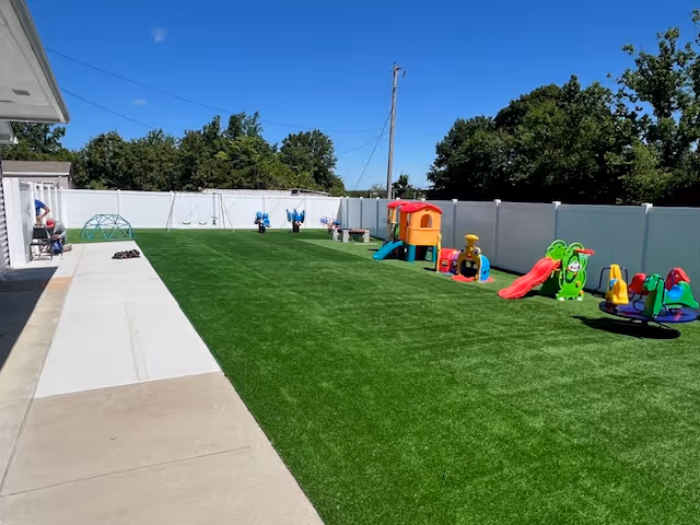 Outdoor playground and turf yard at Attending Angels Home Care and Adult Day Center.