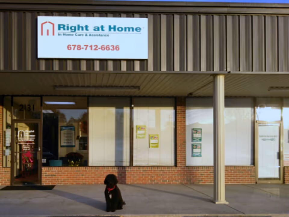 Exterior view of Right at Home facility with a black dog outside