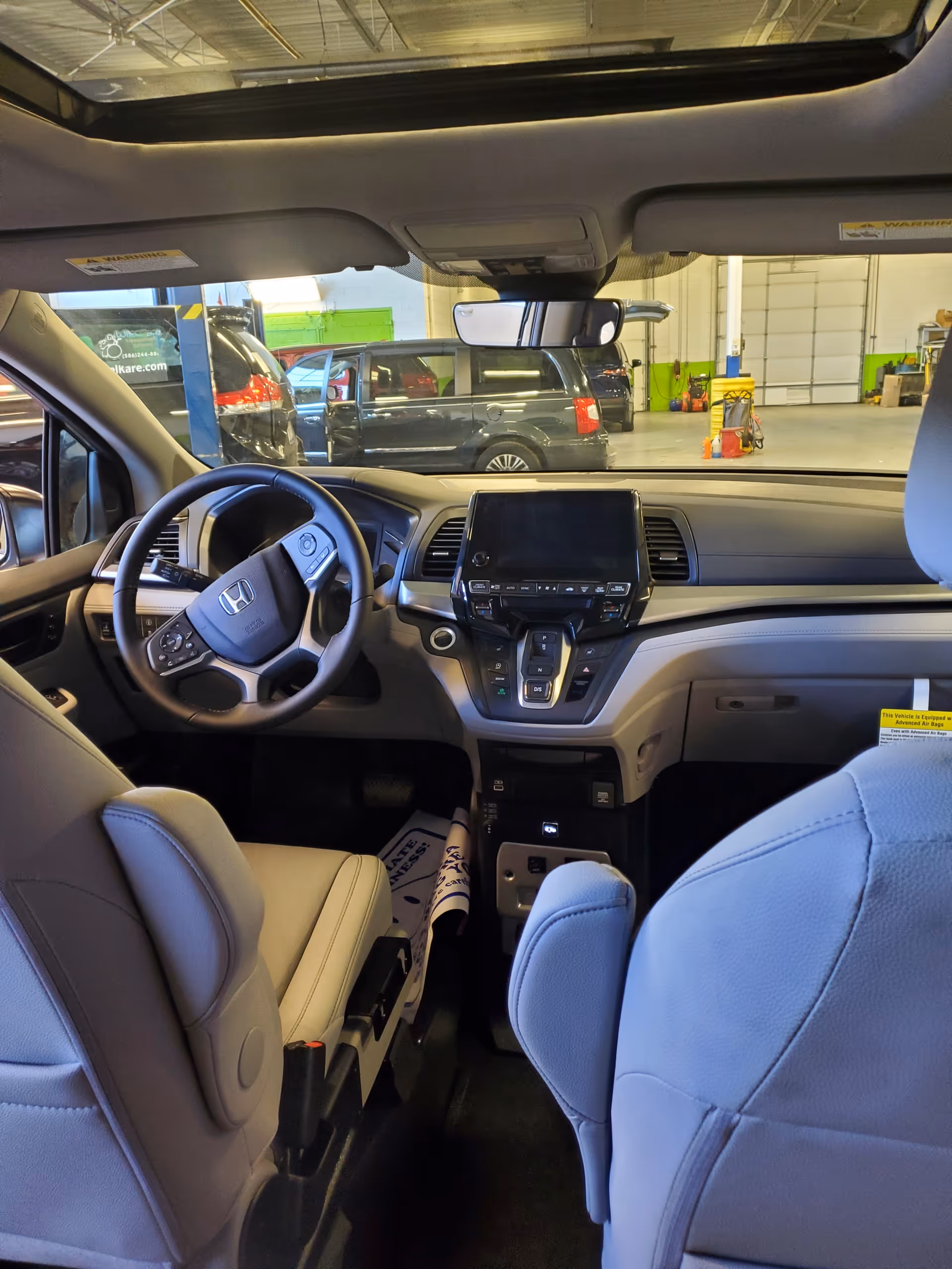 Interior of a mobility van, front seats and dashboard visible from the rear.