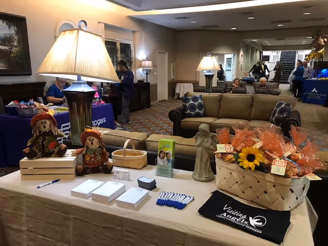 Senior living facility lobby with a long display table and sofa seating