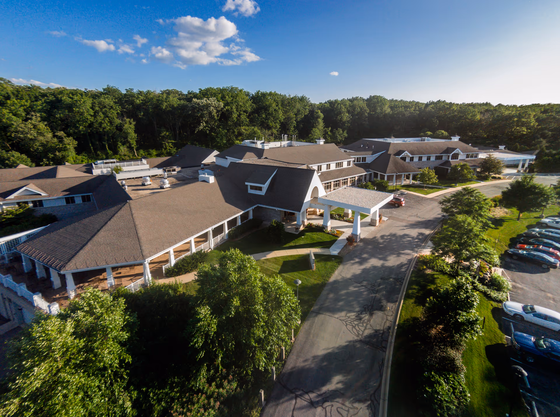 Aerial view of Agrace senior living campus with interconnected buildings and parking.
